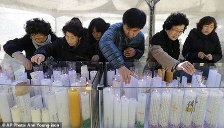 Phụ huynh thắp nến cầu nguyện cho con em mình tại một ngôi đền ở Seoul